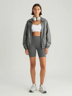 Grey Windbreaker + White Longline Bra + Grey Biker Shorts + Trail Runners
